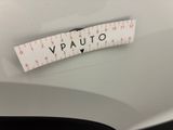 a close up of a sticker on the hood of a white car