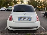 a small white car parked in a parking lot