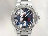 a close up of a watch with a blue dial on a silver bracelet