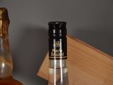 a bottle of alcohol sitting next to a bottle of liquor
