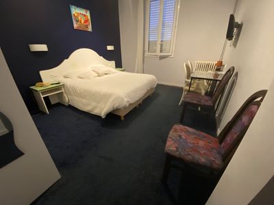 a bedroom with a bed, desk and chair in it