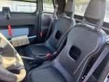 the interior of a car with two black seats and a steering wheel
