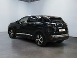 the rear end of a black suv parked in a showroom