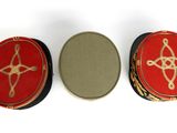 three red boxes with gold designs on them sitting next to each other