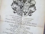 an old book with a black and white drawing of a coat of arms