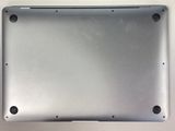 the bottom of a silver laptop with a small hole in the middle