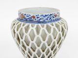 a white vase with a blue and white design on it