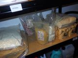 many bags of food sitting on a shelf in the kitchen