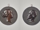 two silver medals of women and men on a white background