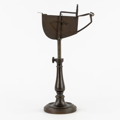an old metal object on a stand with a white background