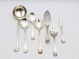 a lot of silver spoons and forks on the table