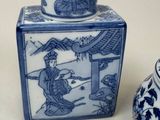 a small blue and white vase and a small blue and white vase