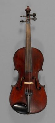 an old violin is hanging on a wall in a room
