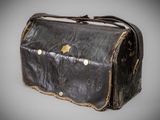 an old black leather bag with a star on it