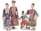 three figurines of asian people are standing next to each other