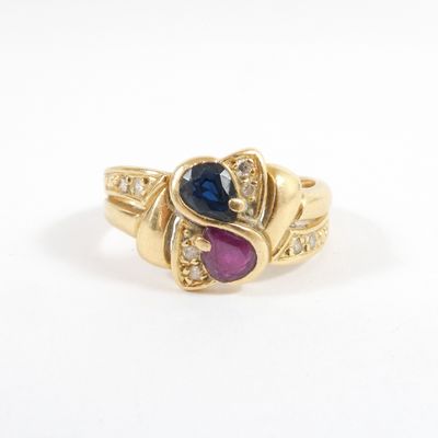 a close up of a gold ring with a blue and pink stone