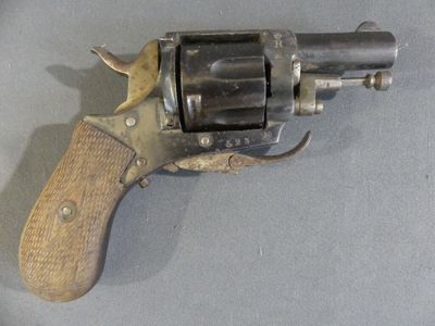 a small revolver with a wooden handle on a table