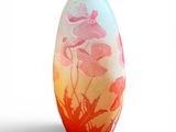 a glass vase with flowers on it on a white background