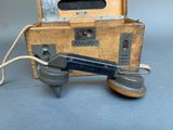 an old fashioned telephone sitting on top of a wooden box