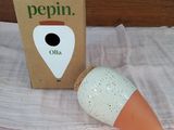 a small orange and white object sitting next to a box
