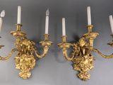 pair of antique brass wall sconces with lion heads and candles