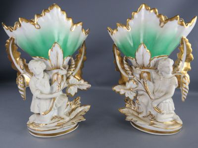 pair of white and green vases with angels on them