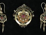 three pieces of jewelry are displayed on a black surface