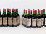 several bottles of wine are lined up on a white surface