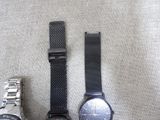 two watches are sitting next to each other on a table