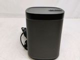 a close up of a black speaker sitting on top of a table