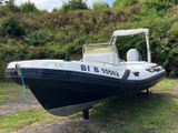 a black and white boat sitting on the grass
