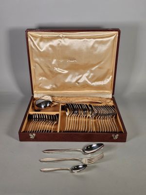 des couverts dans un coffret en bois, posés sur une table