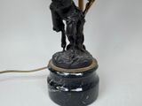 a lamp that has a statue on top of it