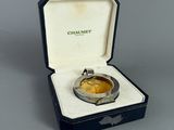 a watch in a box that is open on a table