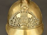 an old gold helmet with a crown on top of it