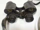 an old pair of binoculars sitting on top of a white table