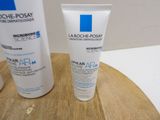 a bottle of lotion and a tube of lotion sitting on a table