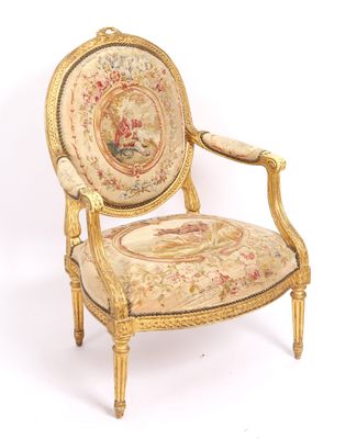 a chair that has a tapestry on the back of it
