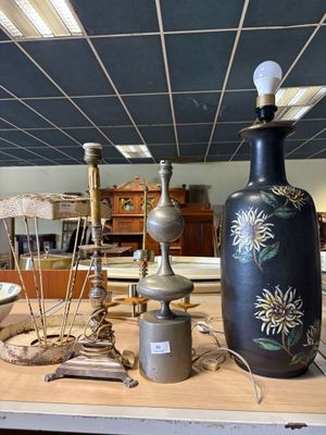 a table with a vase, lamp, and other items on it
