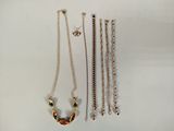 a lot of necklaces that are laying on a table