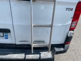 a ladder attached to the back of a white truck