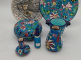 three pieces of blue and green pottery sitting on top of a table