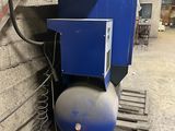 a blue tank sitting on a pallet next to a blue machine