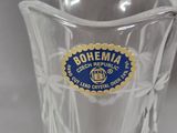 a clear glass vase with a blue label on it