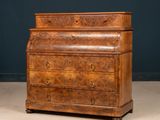 an old wooden chest of drawers sitting on top of a floor