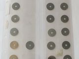 a lot of different types of coins in a display case