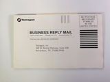 a business reply mail sitting on top of a desk