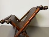 a wooden chair that is on top of a table