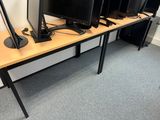 four computer monitors sitting on a desk in a room