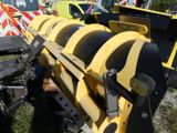 a large yellow machine that is sitting in the grass